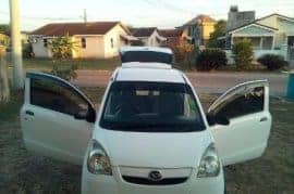 White 2 door hatchback Daihatsu Mira.